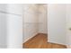 Walk-in closet with hardwood flooring and white shelving at 19740 N Wind Rose Way, Surprise, AZ 85374