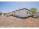 Backyard with desert landscaping, partial sunshade over patio, and gravel yard at 2068 E Orange St, Tempe, AZ 85281