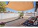 Relaxing backyard with sunshade, desert landscaping, and a gravel area with two chairs at 2068 E Orange St, Tempe, AZ 85281