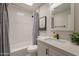 Bright bathroom featuring modern fixtures, a shower with white subway tile, and decorative art at 2068 E Orange St, Tempe, AZ 85281