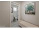Bathroom view from hallway with vanity, toilet, shower, and decorative painting at 2068 E Orange St, Tempe, AZ 85281