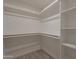 Walk-in closet with multiple levels of shelving and hanging rods at 2068 E Orange St, Tempe, AZ 85281