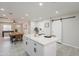 Kitchen island with bar stools, open floor plan to dining area and living room at 2068 E Orange St, Tempe, AZ 85281