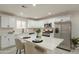 Modern kitchen featuring white cabinetry, stainless steel appliances, and a center island at 2068 E Orange St, Tempe, AZ 85281