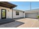 Rear entrance featuring an updated door, well-kept siding, and a convenient detached two-car garage at 2316 N Mitchell St, Phoenix, AZ 85006