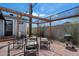 Backyard patio with a shade structure, seating, and a grill, ideal for outdoor relaxation and cooking at 2316 N Mitchell St, Phoenix, AZ 85006