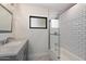 Bathroom with a bathtub shower combo featuring white subway tile and a black trimmed window at 2316 N Mitchell St, Phoenix, AZ 85006