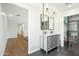 Bathroom showcasing a double sink vanity, glass shower, and black tile floors at 2316 N Mitchell St, Phoenix, AZ 85006