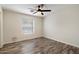 Bedroom featuring hardwood floors, white walls, and a window with wood blind coverings at 2316 N Mitchell St, Phoenix, AZ 85006