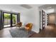 Cozy living room with hardwood floors, seating area, and glass doors to private outdoor space at 2316 N Mitchell St, Phoenix, AZ 85006