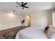 Bright main bedroom with wood floors, ceiling fan, and views into an open hallway at 2316 N Mitchell St, Phoenix, AZ 85006