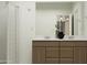 Modern bathroom with double sinks, white countertops, and a glass-enclosed shower at 23196 W Marguerite Ave, Buckeye, AZ 85326