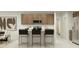 Modern kitchen featuring a breakfast bar, stainless steel appliances, and light wood cabinetry at 23196 W Marguerite Ave, Buckeye, AZ 85326
