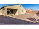 A spacious backyard featuring a covered patio, block wall fencing and neutral stucco, perfect for outdoor relaxation at 23789 W Chipman Rd, Buckeye, AZ 85326