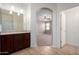 Bathroom showcasing vanity with arched doorway to main bedroom at 23789 W Chipman Rd, Buckeye, AZ 85326