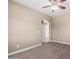 Bedroom with neutral carpet and archway into bathroom at 23789 W Chipman Rd, Buckeye, AZ 85326