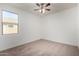 Bedroom with neutral carpet, a window, and ceiling fan with lighting at 23789 W Chipman Rd, Buckeye, AZ 85326