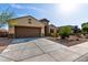 Beautifully landscaped front yard with charming single-story home and attached two-car garage at 23789 W Chipman Rd, Buckeye, AZ 85326