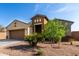Inviting front exterior of a single-story home with desert landscaping and a brown garage door at 23789 W Chipman Rd, Buckeye, AZ 85326