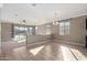 Open-concept living room with tile flooring and sliding glass doors to the backyard at 23789 W Chipman Rd, Buckeye, AZ 85326