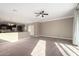 Open-concept living room boasting ample natural light, plush carpeting, and modern fixtures at 23789 W Chipman Rd, Buckeye, AZ 85326
