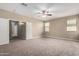 Large main bedroom with a ceiling fan and neutral carpeting at 23789 W Chipman Rd, Buckeye, AZ 85326