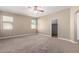 Spacious main bedroom featuring two large windows and neutral carpeting at 23789 W Chipman Rd, Buckeye, AZ 85326
