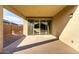 A covered patio with a sliding glass door that provides natural light and access to the interior at 23789 W Chipman Rd, Buckeye, AZ 85326