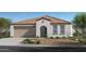 Charming single-story home showcasing a tile roof, arched entryway, and low-maintenance desert landscaping at 24649 W Jessica Ln, Buckeye, AZ 85326