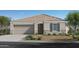 Charming single-story home featuring a two-car garage and desert landscaping at 24659 W Wayland Dr, Buckeye, AZ 85326