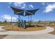 Community playground with slides and climbing equipment under a shaded canopy at 24659 W Wayland Dr, Buckeye, AZ 85326