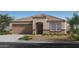 Charming single-story home with a two-car garage, desert landscaping, and a tile roof at 24661 W Jessica Ln, Buckeye, AZ 85326