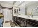 Bathroom showcasing a dual-sink vanity, large mirror, and a walk-in shower with sleek fixtures at 26049 W Matthew Dr, Buckeye, AZ 85396
