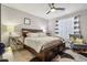 Cozy bedroom with a ceiling fan, patterned rug, and a comfortable seating area near the window at 26049 W Matthew Dr, Buckeye, AZ 85396