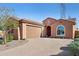 Charming single-story home featuring a tile roof, arched window and a brick-paved driveway and walkway at 26049 W Matthew Dr, Buckeye, AZ 85396