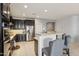 Modern kitchen with stainless steel appliances, stylish dark wood cabinets and a breakfast bar with seating at 26049 W Matthew Dr, Buckeye, AZ 85396
