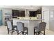 Stylish kitchen with dark wood cabinets, stainless appliances, and an island with seating at 26049 W Matthew Dr, Buckeye, AZ 85396