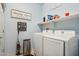 Functional laundry room with new appliances and decorative wall decor at 26049 W Matthew Dr, Buckeye, AZ 85396