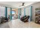 Bright room featuring floor-to-ceiling windows, a ceiling fan, and a comfortable massage chair at 26049 W Matthew Dr, Buckeye, AZ 85396