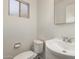 A modest bathroom with a toilet, sink, and mirrored cabinet at 2808 W Lawrence Rd, Phoenix, AZ 85017