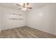 Bedroom with plank floors, overhead fan, and rustic wood shelving for an airy feel at 2808 W Lawrence Rd, Phoenix, AZ 85017