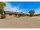 View of single story brick home with gravel front yard and blue skies at 2808 W Lawrence Rd, Phoenix, AZ 85017