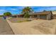 Brick single story home featuring a gravel front yard and concrete driveway at 2808 W Lawrence Rd, Phoenix, AZ 85017