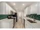 Bright kitchen featuring stainless steel appliances, white cabinets, and tiled flooring at 2808 W Lawrence Rd, Phoenix, AZ 85017
