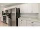 Updated kitchen with white cabinets, stainless steel appliances, and modern countertops at 2808 W Lawrence Rd, Phoenix, AZ 85017