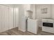 Bright laundry room offers a washer, dryer, storage, and durable flooring at 2808 W Lawrence Rd, Phoenix, AZ 85017