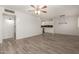 Well-lit living room featuring tiled flooring, a ceiling fan, and access to the kitchen at 2808 W Lawrence Rd, Phoenix, AZ 85017