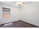 A bedroom with neutral carpet, white walls, a ceiling fan, and a window at 2810 N 112Th Ln, Avondale, AZ 85392