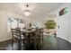 Dining room with chandelier, tile flooring and a view into the living area at 2810 N 112Th Ln, Avondale, AZ 85392