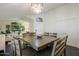 Dining room showcases a modern chandelier and ample natural light from large windows at 2810 N 112Th Ln, Avondale, AZ 85392